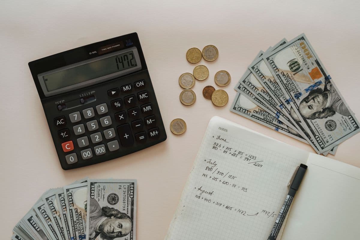 Flat lay of calculator, coins, and notes for budget planning