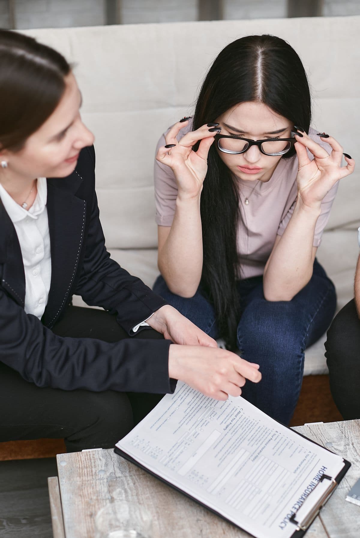 Businesswomen discussing contract details while reviewing documents