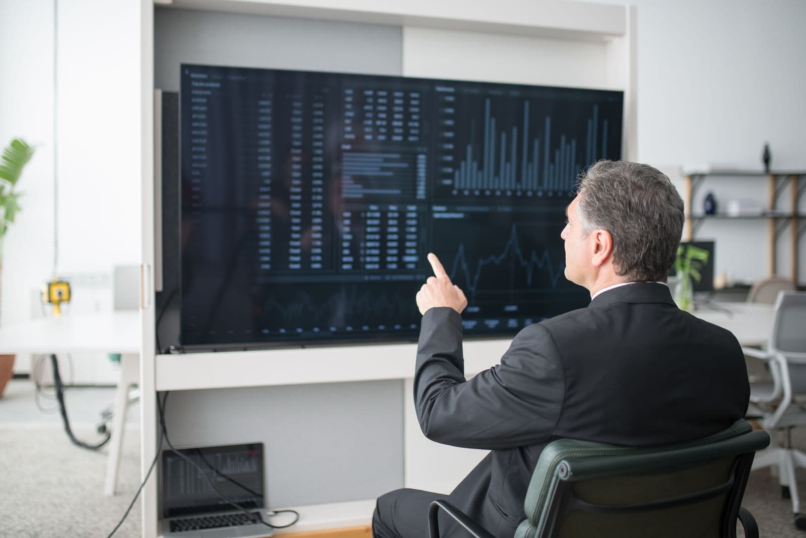 Analyst reviewing a business intelligence dashboard on screen