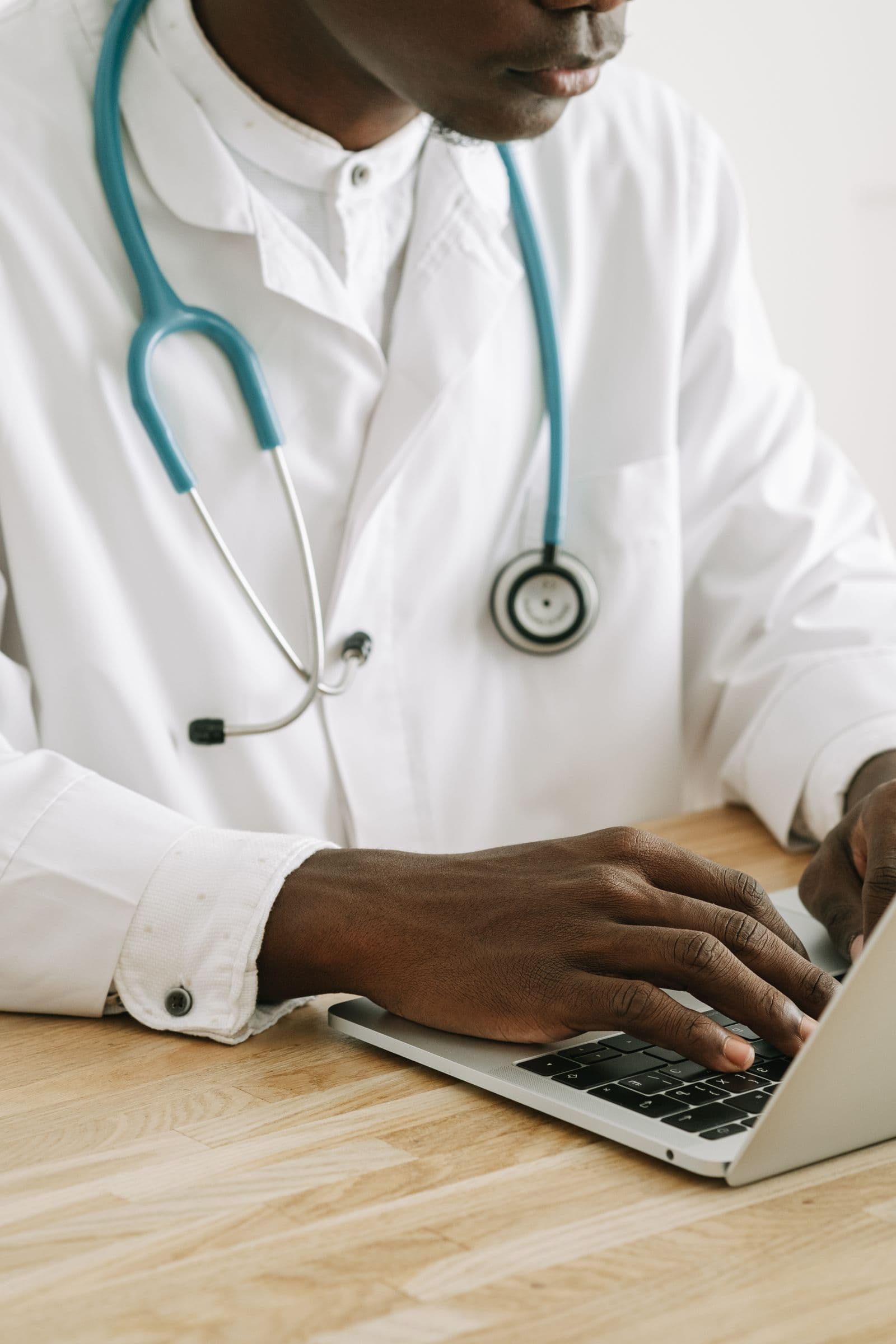 Medical biller reviewing coding documents at a desk