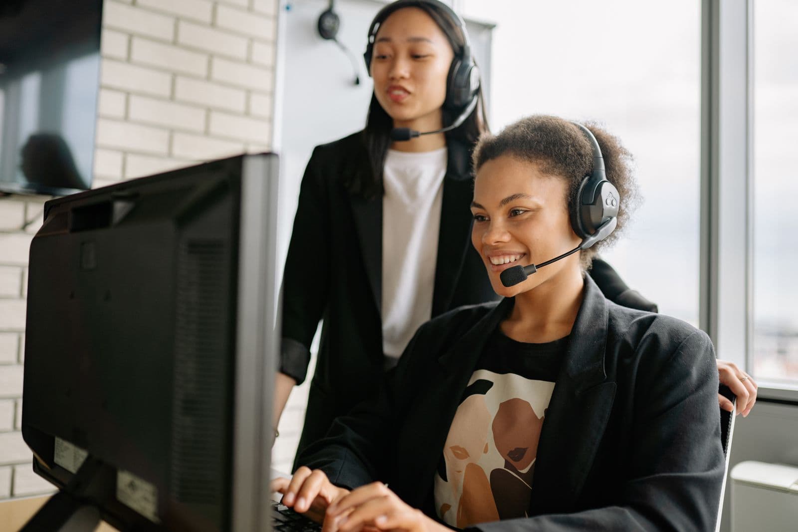 Customer service representatives assisting clients at their desks