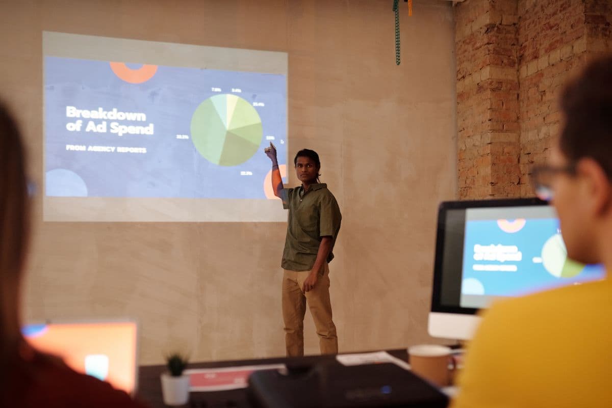 Young professional delivering a business presentation with charts