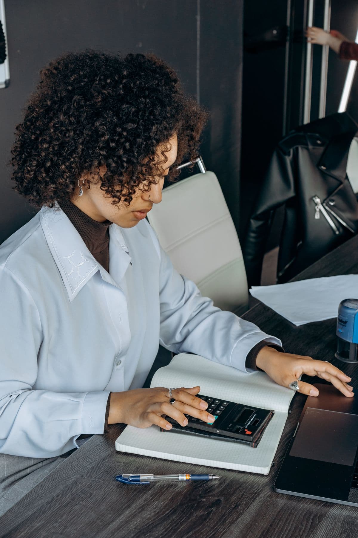 Accountant working on insurance agency books at a desk