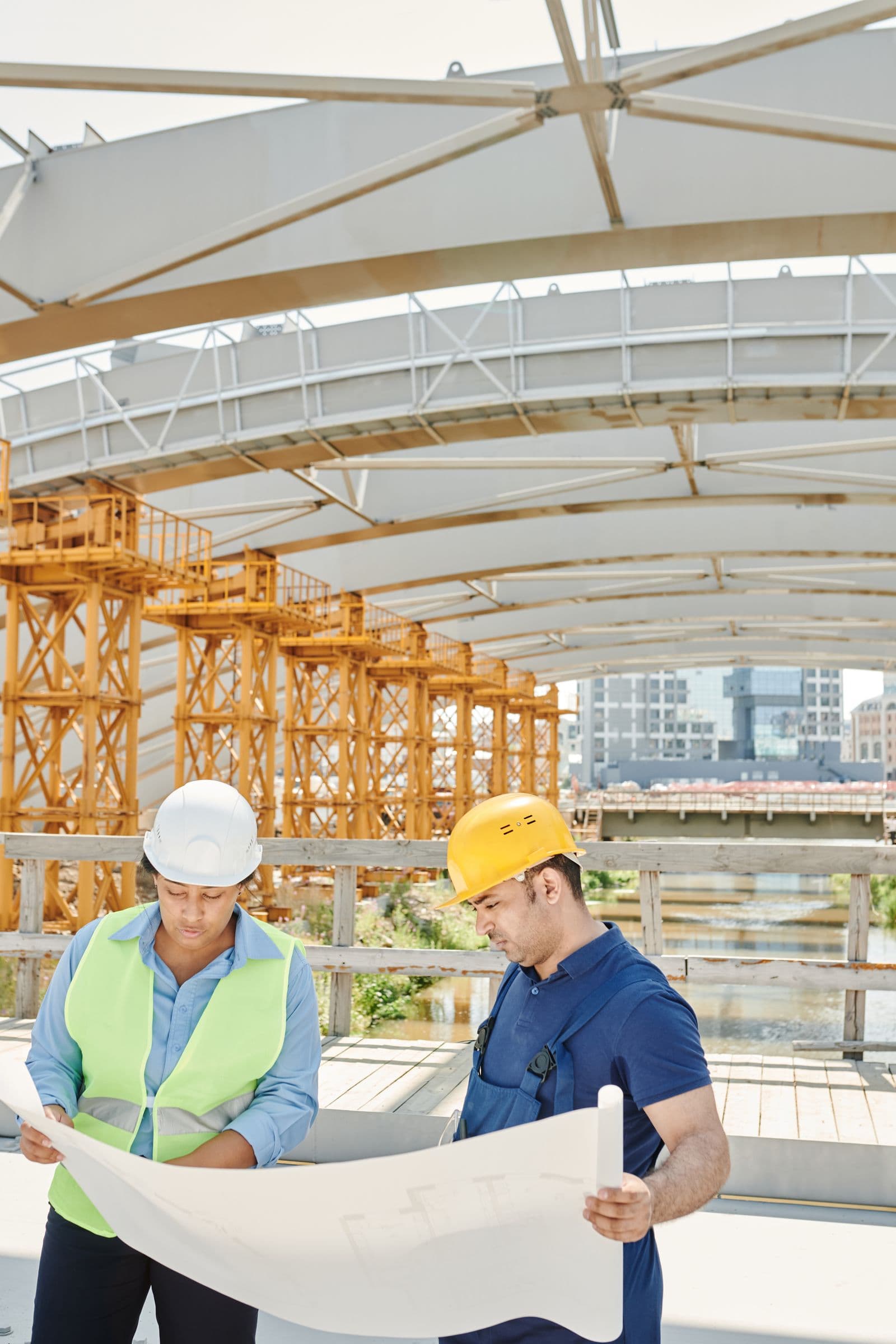 Engineers reviewing blueprints at a construction site