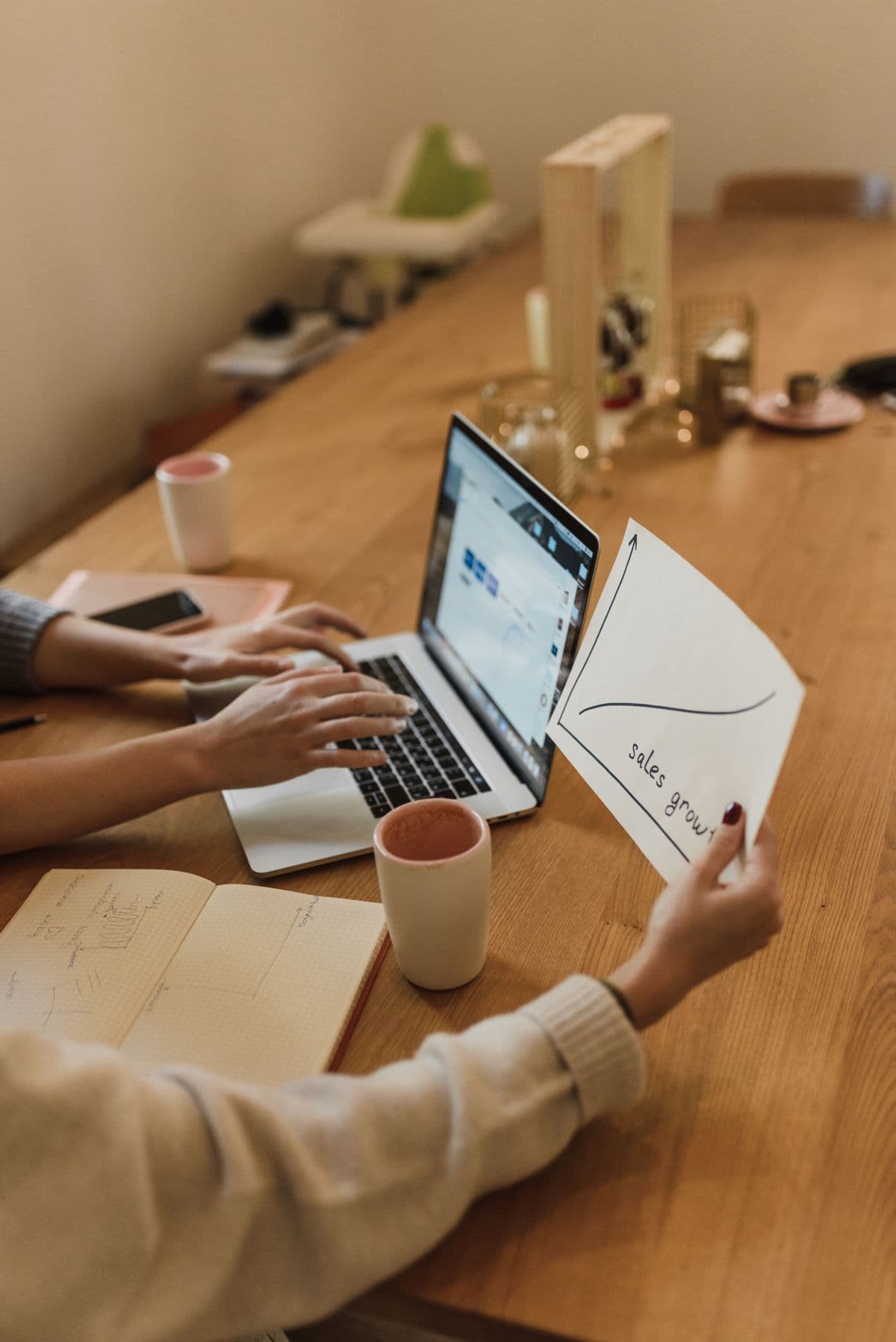 Team analyzing a sales growth chart during an office meeting