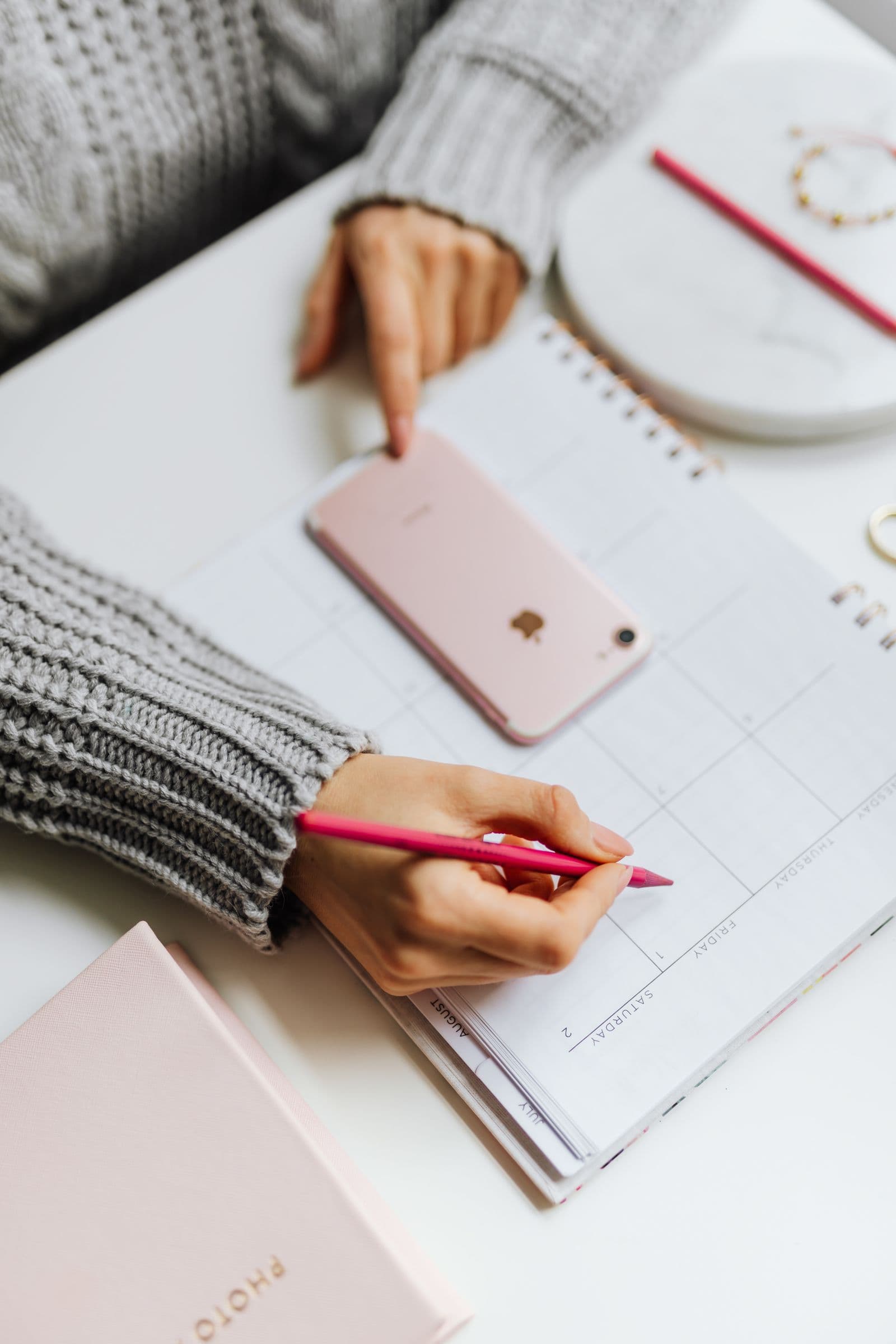 Receptionist scheduling a patient appointment at the front desk