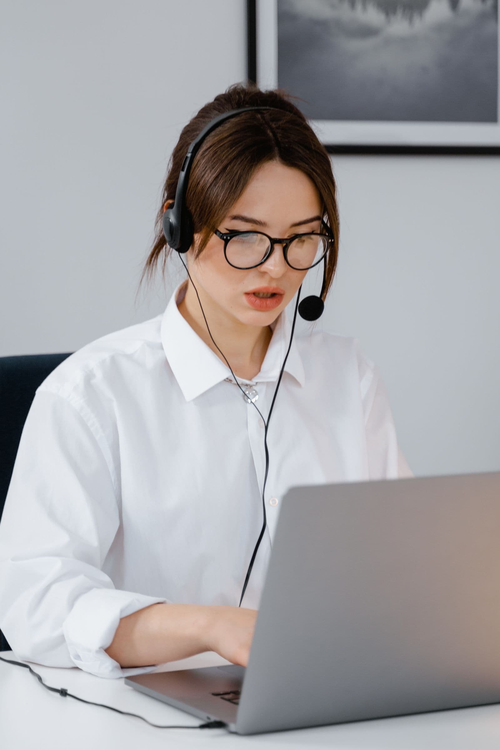 Virtual assistant wearing a headset working at a computer