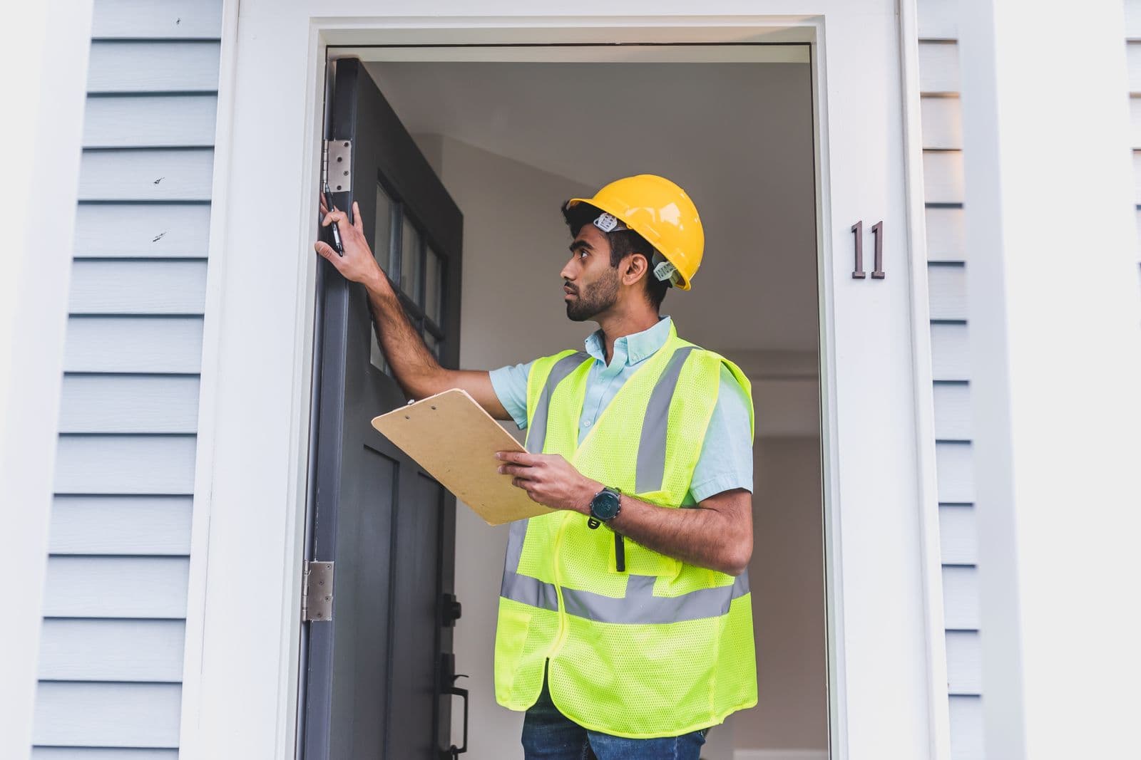 Home inspector reviewing a property with a clipboard